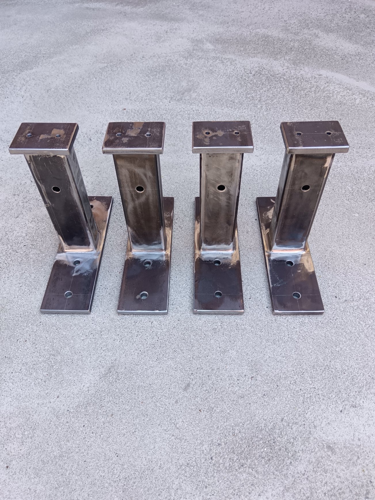 Example of welded mild-steel support brackets / mounting posts produced in small batch.  The parts consist of rectangular hollow sections, drilled base plates and top plates, welded by MIG/MAG process. Such components can be used as equipment supports, mounting brackets, auxiliary machine-frame elements or prototype support structures.  Production can be carried out according to customer drawings or technical documentation.